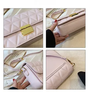 Close-up of pink quilted flap bag with golden metal buckle and precise stitching details