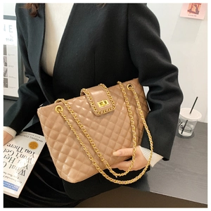 Detail of khaki quilted tote bag featuring gold chain strap and elegant turn-lock closure