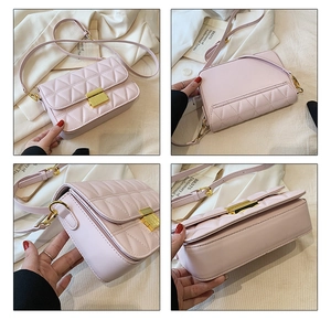 Detail of pink quilted crossbody bag showing gold buckle and fine stitching craftsmanship