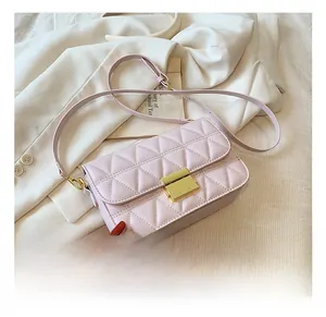 Detail showing pink quilted leather texture and gold square buckle of the shoulder bag