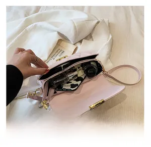 Internal capacity of pink quilted crossbody bag with golden clasp and personal items