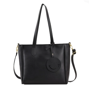 Large black matte tote bag with dual handles, detachable strap and minimalist charm