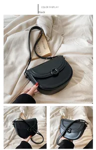 Detailed views of a black faux leather saddle bag with round buckle and adjustable strap