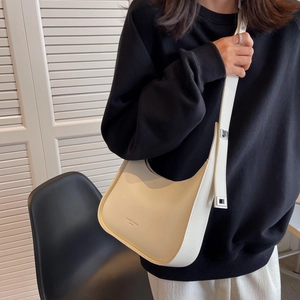 Chic cream-colored leather half-moon crossbody bag with adjustable wide shoulder strap