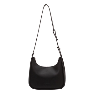 Minimalist black crescent hobo shoulder bag in textured leather with adjustable strap