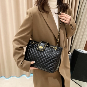 Quilted black leather tote bag with gold chain strap and elegant turn-lock closure