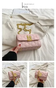 Close-up of pink quilted crossbody bag with a gold rabbit-shaped lock and chain strap