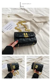 Detail of black quilted handbag with gold rabbit ear clasp and metal chain strap