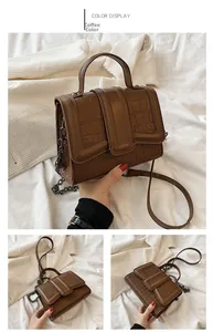 Detail of coffee brown crocodile pattern shoulder bag with metallic chain strap
