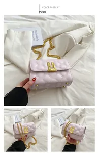 Detailed macro view of purple quilted bag with golden rabbit ear buckle and metal base studs