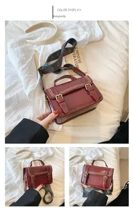 Détail du sac vintage bordeaux avec clous perlés et bandoulière en jacquard