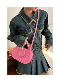 Pink faux crocodile leather crossbody bag styled with a vintage denim outfit