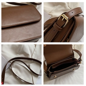 Detailed close-up of brown faux leather crossbody bag with gold hardware and interior pocket