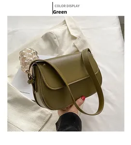 Detailed close-up of the olive green PU leather crossbody bag with a matte finish