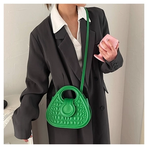 Detailed view of neon green crocodile pattern handbag with a unique circular cutout handle