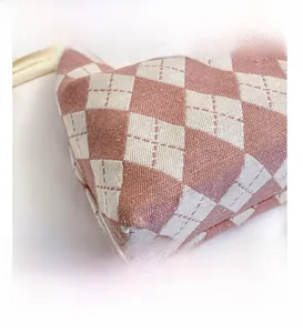 Detail shot of pink and white argyle knitted fabric texture and fine craftsmanship