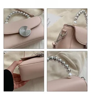 Detailed views of light pink handbag with pearl handle and silver metal hardware