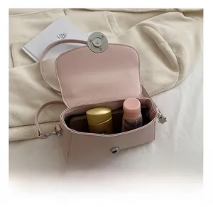 Detail view of pink mini crossbody bag interior showing space for phone and makeup