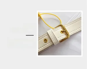 Detail magnification of white leather belt with golden square buckle and reinforced eyelets