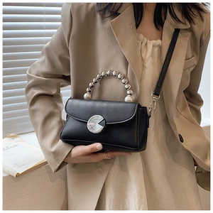 Detail of black mini crossbody bag with silver beaded handle and metal twist lock closure