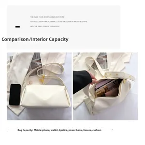Detail of cream white leather shoulder bag showing wide adjustable strap and inner storage