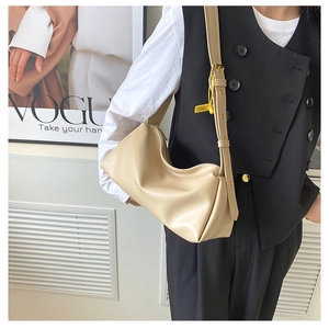 French style creamy beige shoulder bag with wide strap and yellow tag detail