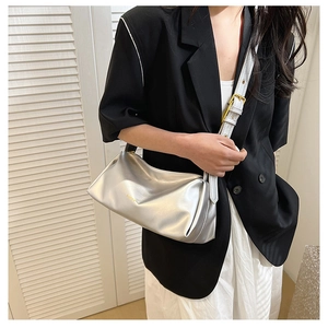 Chic silver crescent moon bag with metallic pleated finish and adjustable strap
