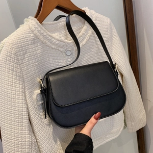 Classic black flap shoulder bag in matte synthetic leather with gold hardware detail