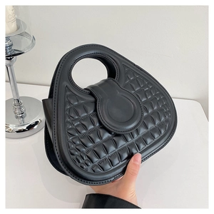 Fashionable black embossed handbag with unique round cutout handle and textured finish