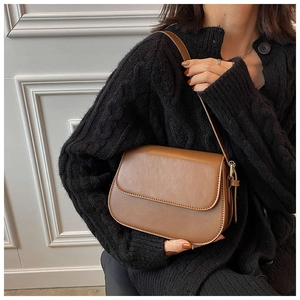 Classic brown leather saddle crossbody bag for women with minimalist vintage style