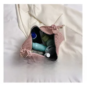 Detail view of pink cloud bag interior showing large capacity for cosmetics and phone