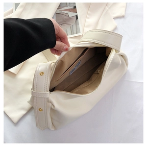 Interior view of off-white crescent handbag with smooth PU texture and zipper pocket