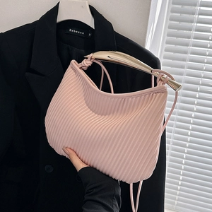 Pink pleated square bag with a sleek gold metal handle and crossbody strap for women