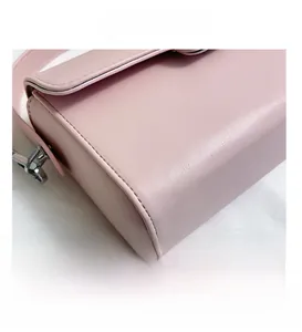 Detail view of pink vintage crossbody bag showing stitching and fine leather texture