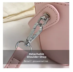 Close-up of pink PU leather small square bag featuring a silver detachable shoulder strap