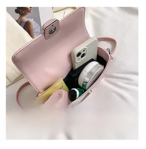 Detail view of pink crossbody bag showing spacious interior with phone and cosmetics