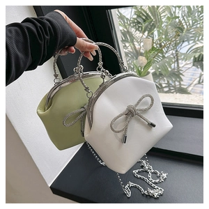 Detailed shot of two vintage kiss-lock shell bags with rhinestone bows and metal handles