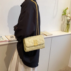 Beige quilted heart pattern flap shoulder bag with gold rabbit clasp and chain strap