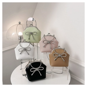 Multiple stylish shell handbags with rhinestone bows and metal chain straps in five colors