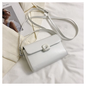 Detailed view of the white vintage square bag with a stylish buckle and leather texture