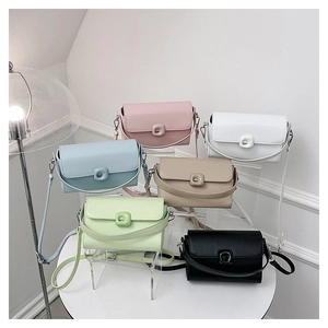 Collection of minimalist crossbody bags in six colors displayed on a tiered stand
