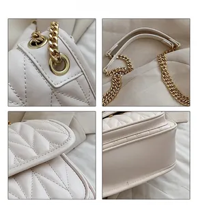 Detailed views of creamy white quilted leather bag with chunky gold chain hardware