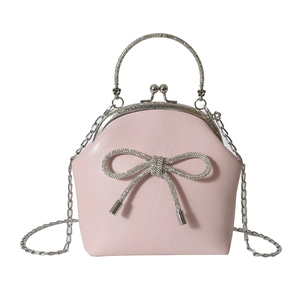 Elegant light pink shell-shaped evening handbag with rhinestone bow and chain strap