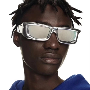 Detail of silver metallic Y2K futuristic sunglasses on model with rectangular frame style
