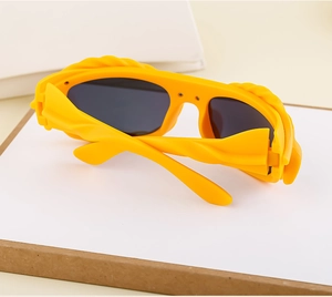 Close-up of bright yellow Y2K sunglasses featuring unique twisted frame texture detail