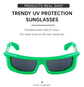 Detail of neon green Y2K sunglasses with thick wrap-around frame and dark grey lenses