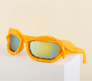 Close-up of vibrant yellow Y2K sunglasses featuring unique wavy embossed textures and mirrored lenses