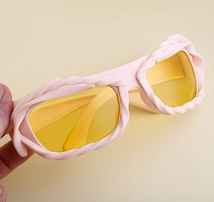 Detail of pink woven frame sunglasses with yellow lenses and unique twisted texture