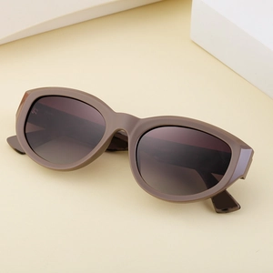 Detailed top view of matte taupe cat-eye sunglasses on a clean minimalist background