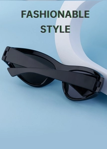 Detail of black Y2K cat-eye sunglasses with wide temples on a display stand